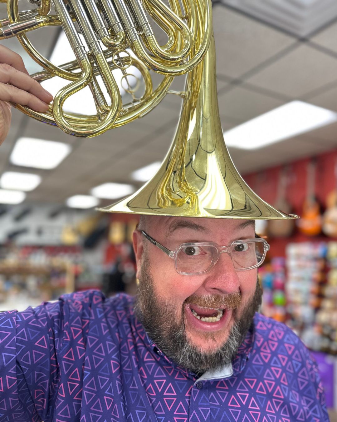 Co-owner of Brighton Music with tuba on his head